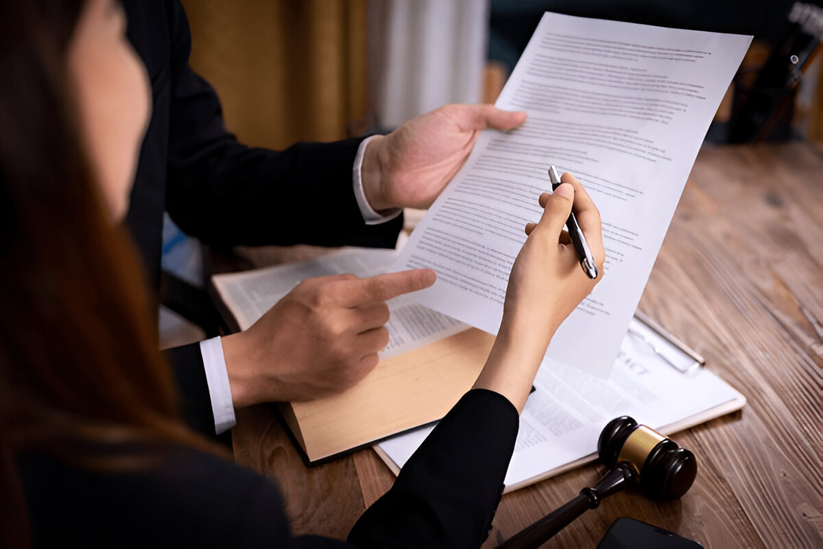 "Buyer reviewing documents and discussing property details with real estate developer before purchasing new property."